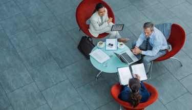 Businesspeople discussing strategy at coffee table