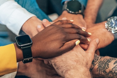 stacked hands in huddle
