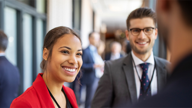 Two people smiling at an event
